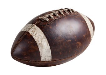 A vintage leather football isolated against a dark solid black background