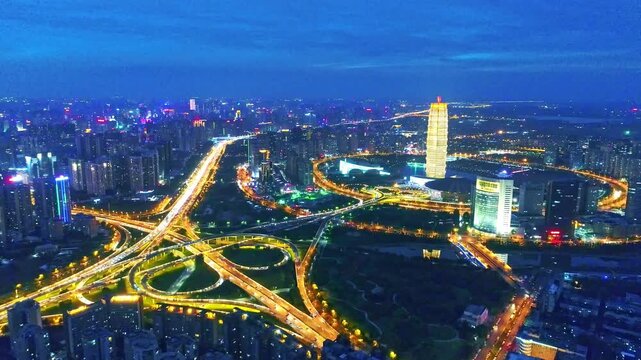 Zhengzhou City Skyline at Night with Illuminated Highway Interchange and Modern Buildings, China