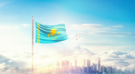 Kazakhstan flag wavering in beautiful clouds with building skyline. The flag with drone shot in...