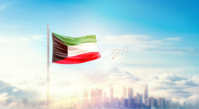 Kuwait flag wavering in beautiful clouds with building skyline. The flag with drone shot in beautiful sky. Kuwait national flag for independence day. - Powered by Adobe