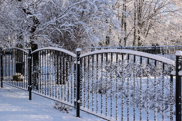 Metal fence dusted with snow