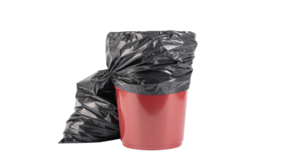 Red trash can with a black trash bag inside and another full black trash bag next to it, isolated on white background png with transparency
