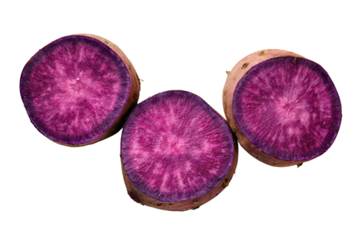 Vibrant purple sweet potato slices, isolated on black background