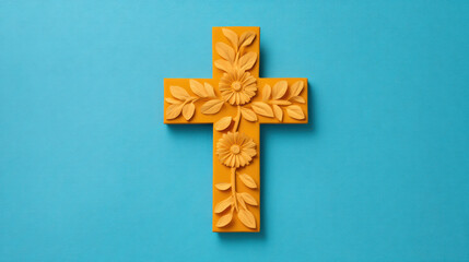 A vibrant, decorative yellow cross with floral designs against a turquoise background, symbolizing faith and creativity.