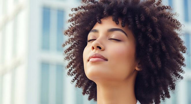 Woman with curly hair breathing deeply outdoors deep breath