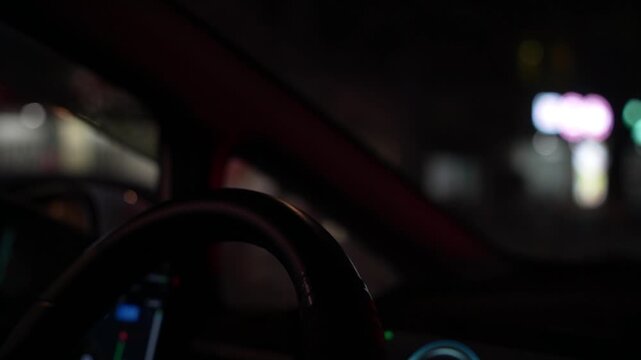 Night Drive Focus on Steering Wheel Waiting at Traffic Light