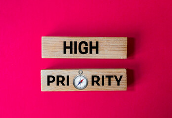 
High Priority: Wooden Blocks with a Compass Symbolizing Focus, Direction, Important Tasks, and Strategic Goal Setting
