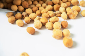 Crispy Coated Peanuts Spilled on White Surface