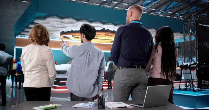 Sales Manager Points At Booth