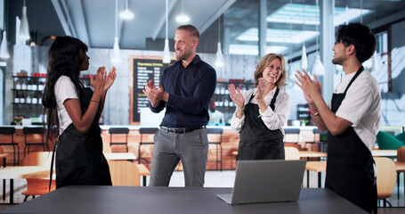 Waiters Celebrate Good News With Team Leader
