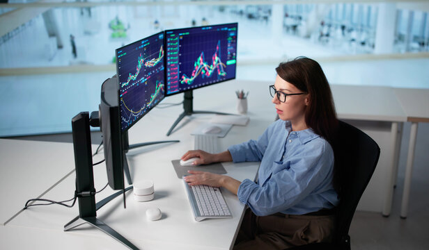 Female Financial Trader Monitoring Multiple Trades