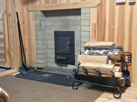 Warm sauna Lounge with Brick Stove and Firewood Rack