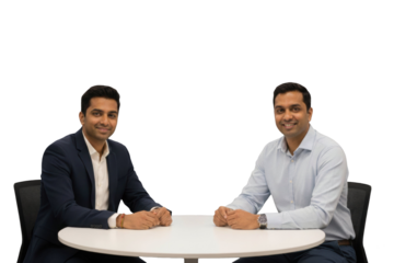 Two Indian business men smiling at modern office table, isolated on transparent background