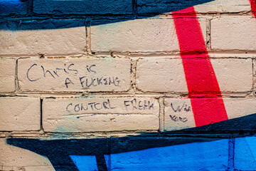 old brick wall with graffiti