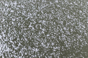 Snow lies on the river ice.