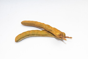 Tamarind is a tangy, sweet-sour tropical fruit used in cooking, drinks, and traditional remedies.
