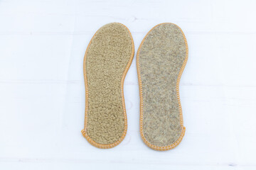 Warm wool insoles for shoes on white background