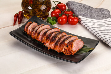 Sliced duck breast baked with cherry