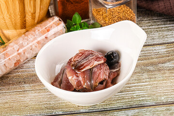 Canned anchovy with oil in the bowl