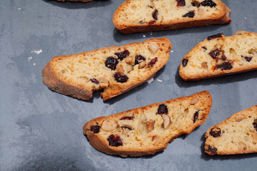 Delicious biscotti cookies with cranberries and nuts on a gray surface