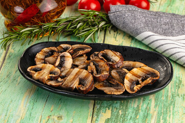 Tasty hot grilled champignon mushrooms