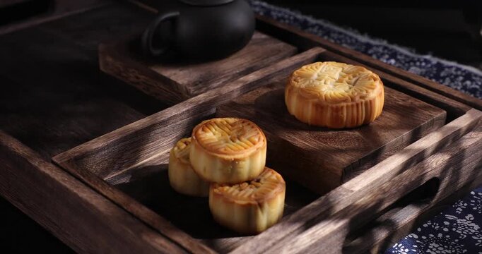Traditional Golden Mooncakes on Wooden Tray for Mid-Autumn Festival Celebration