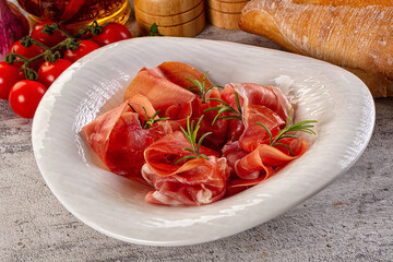Spanish dry jamon serrano pork meat slices