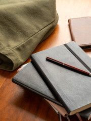 机の上の重なったノートとペンとかばん