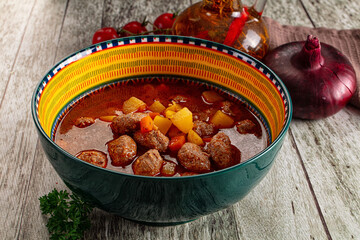 Tomato soup with meatballs and vegetables