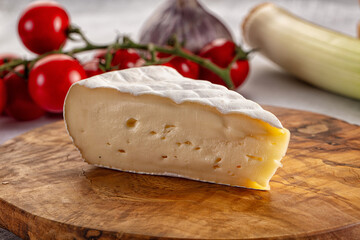 Soft camembert cheese over board