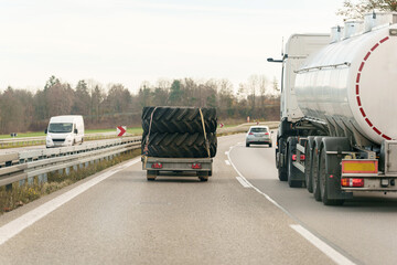 Naklejka premium Heading south on Highway with large tires and an oil tanker truck