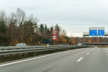 Driving along the autobahn in Deutschland seeing speed limit and no overtaking signs on an overcast...