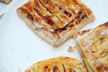 Golden delights a homemade selection of fresh baked fruit pastries dusted with powdered sugar for a morning dessert