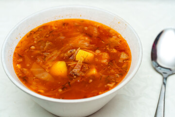 Bowl of Ukrainian Borscht with Potato and Cabbage Ready to be Enjoyed with a Spoon
