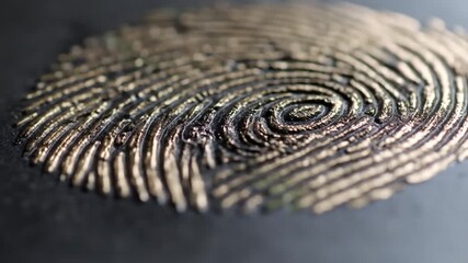 Golden fingerprint on dark background. - Powered by Adobe