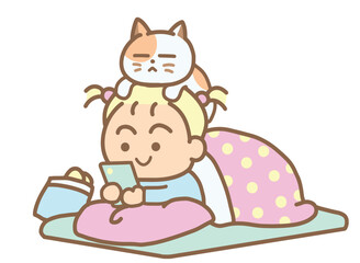 A young girl lies playing with her phone under a warm blanket.