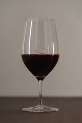 Red wine in thin wine glass on wood table