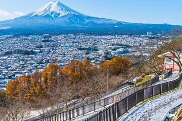 Majestic mount fuji overlooking a snowy japanese town in autumn