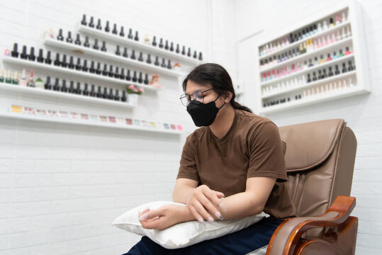 Woman (LGBTQ) do a manicure or pedicure at nails
