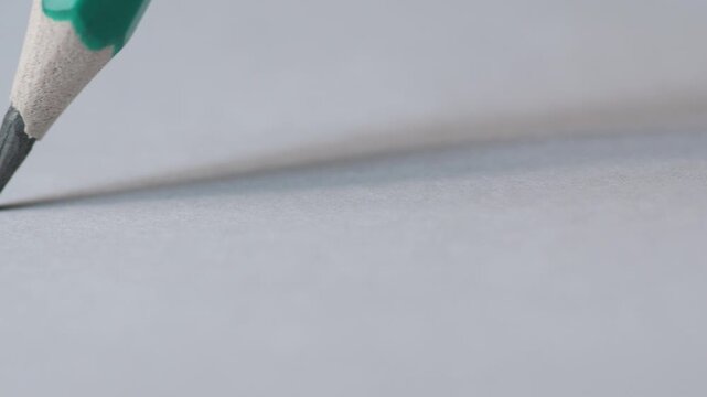 Close-up of Pencil Drawing Line on White Paper, Macro Sketching Art Concept, Creative Process Detail
