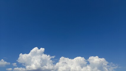Clear Blue Sky and Fluffy Clouds on Sunny Day