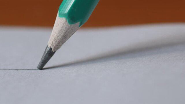 Macro Pencil Drawing Straight Line on Clean White Sheet, Concept of Pencil Sketching on Paper