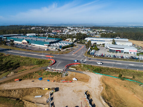 Roads and bridge under construction with industrial area buildings and workshops