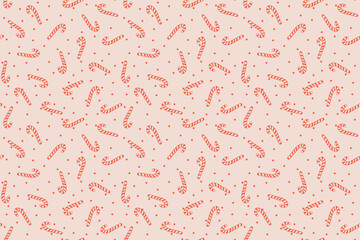 hand-drawn doodle seamless pattern featuring red striped candy canes and polka dots on a pastel pink background. Perfect for textile, fabric, wrapping paper, backgrounds, product packaging, and print 