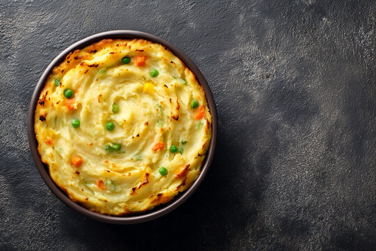 shepherd&rsquo;s pie topped with smooth golden mashed potatoes, showcasing hearty meat filling and rustic homestyle texture.