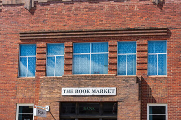 Old historic bank building turned book market shop on sunlit day in country town of Glen Innes