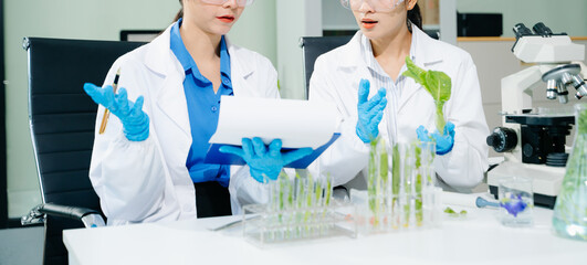 Food scientists in lab coats, testing samples, and analyzing food safety and quality in a modern...