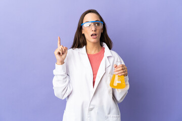 Young scientific woman over isolated background thinking an idea pointing the finger up