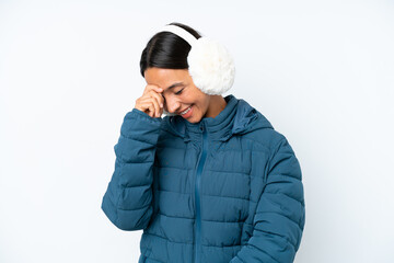 Young hispanic woman wearing a winter earmuffs isolated on white background laughing