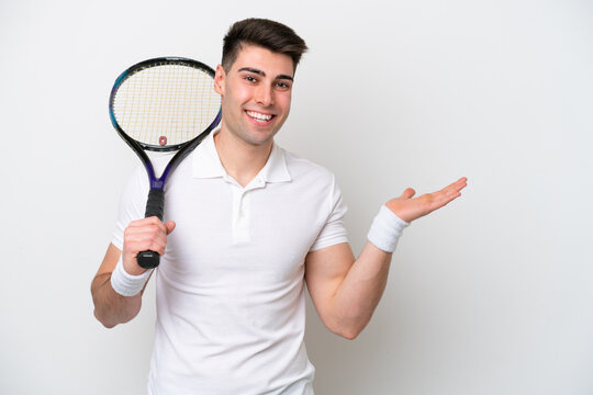 young tennis player man isolated on white background extending hands to the side for inviting to come
